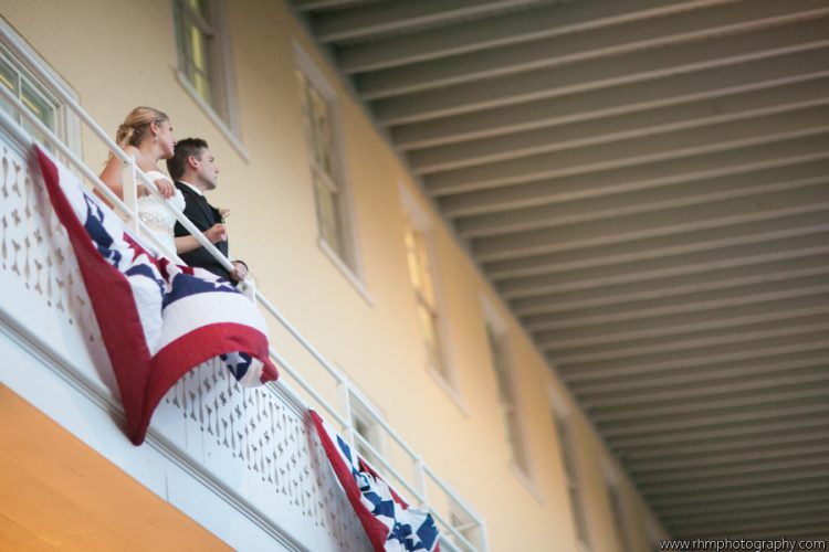 Bride and groom standing together on decorated balcony during wedding celebration