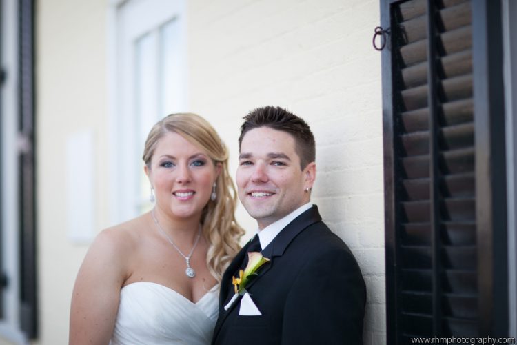 Bride and groom posing together during elegant wedding portrait session