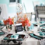 Wedding reception table centerpiece with floral arrangement and reserved seating card