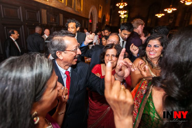 Wedding guests dancing together and celebrating joyfully at lively reception