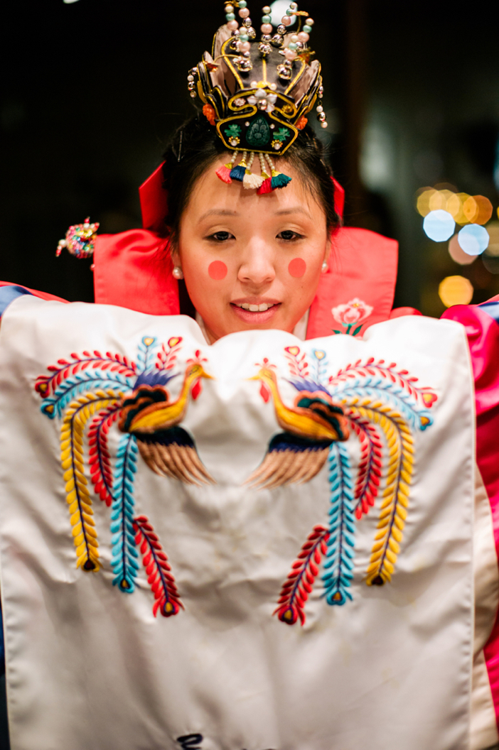 Woman wearing traditional Korean ceremonial attire with ornate embroidered robe and decorative headpiece portrait