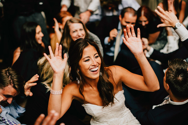 Bride dancing with guests during lively wedding reception celebration