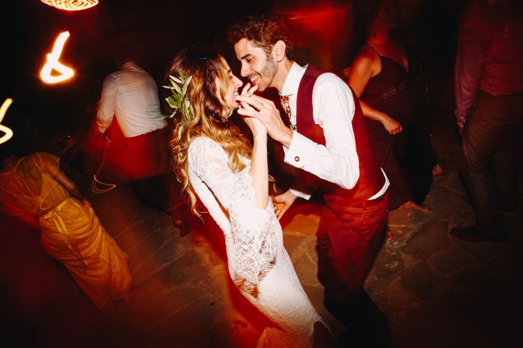 Bride and Groom dancing together during evening wedding reception.