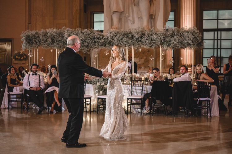 Bride sharing Father-Daughter dance in elegant ballroom reception.