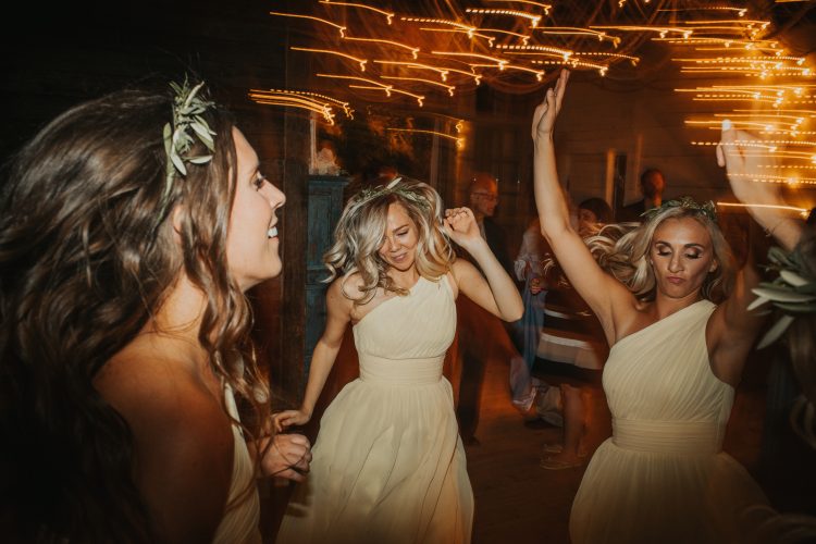Bridesmaids dancing together during wedding reception.