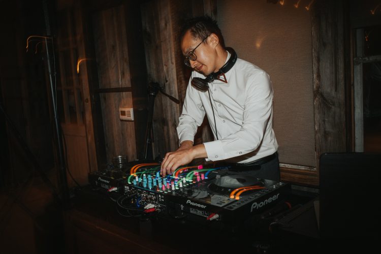 Wedding DJ mixing music during reception set.