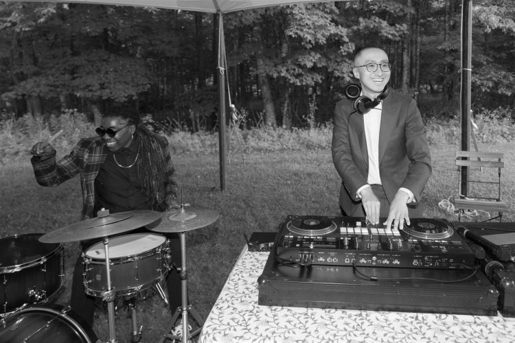  Outdoor Wedding DJ with live drummer performs beside the DJ booth.