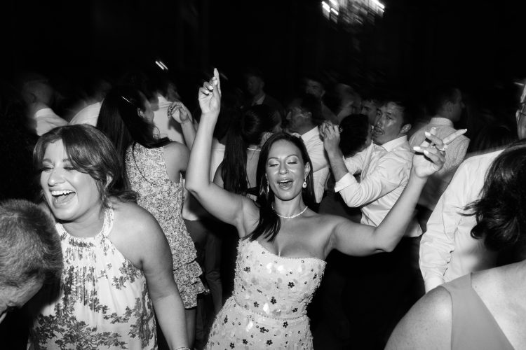 Guest dancing joyfully on the reception dance floor.