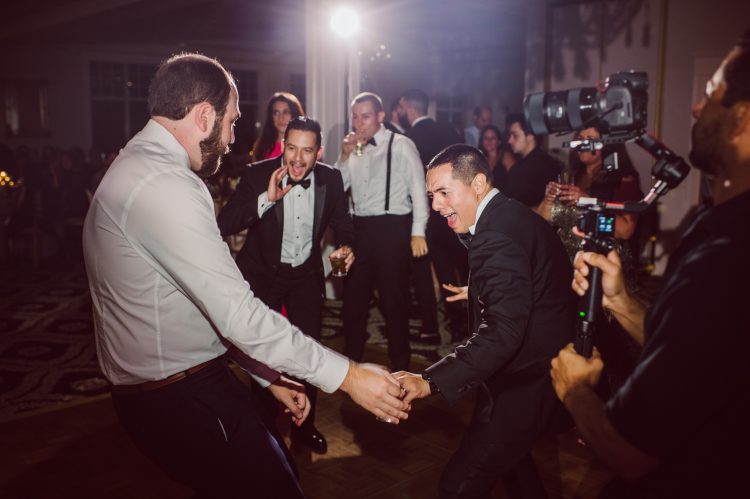 Guests hyping up a friend’s dance move on the dance floor.