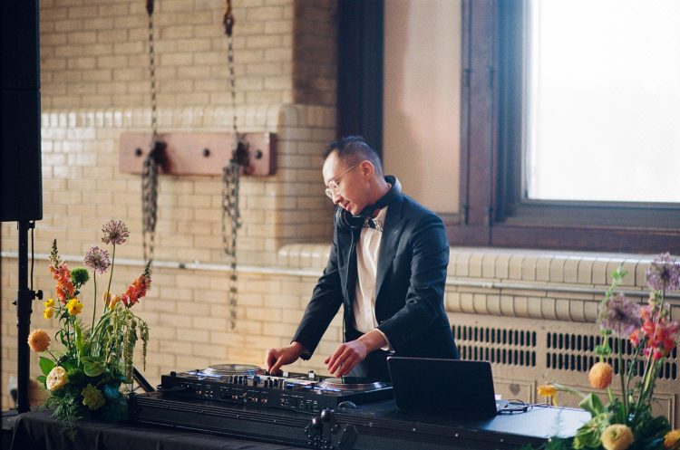 Wedding DJ mixing music during the reception.