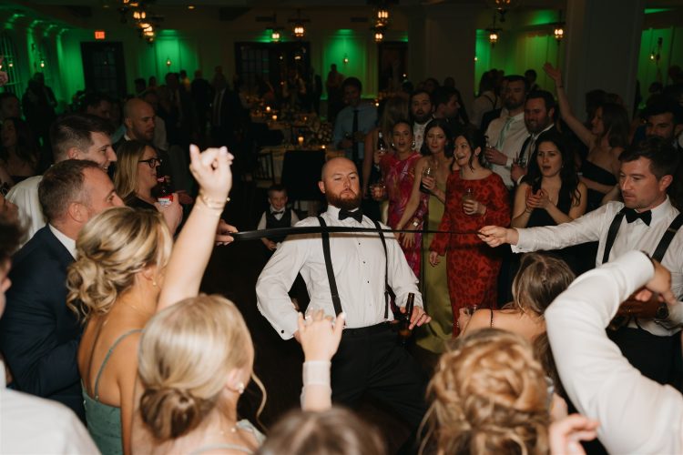 Guest doing the limbo while the crowd cheers around him.