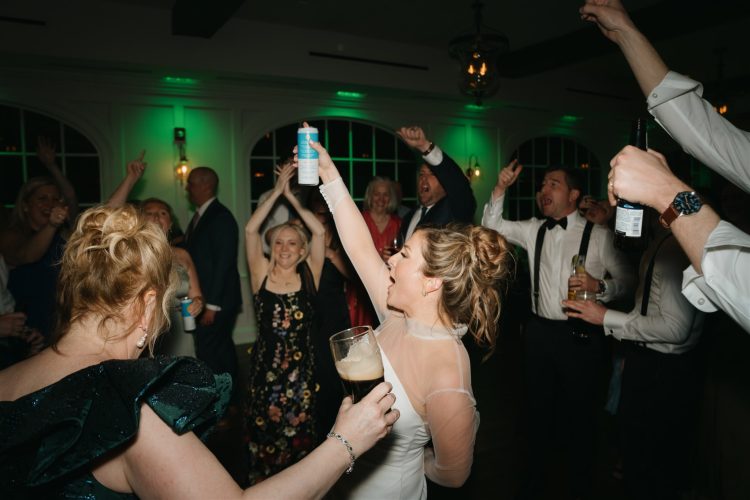 Bride celebrating with guests on the dance floor.