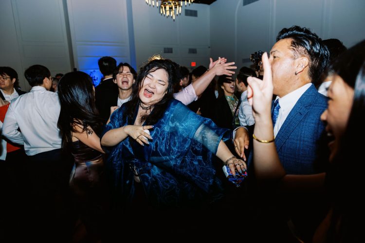 Guest dancing energetically on the crowded dance floor.