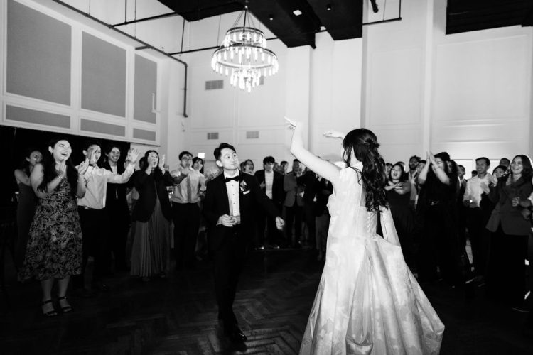 Bride and Groom dancing in the center of a cheering circle.