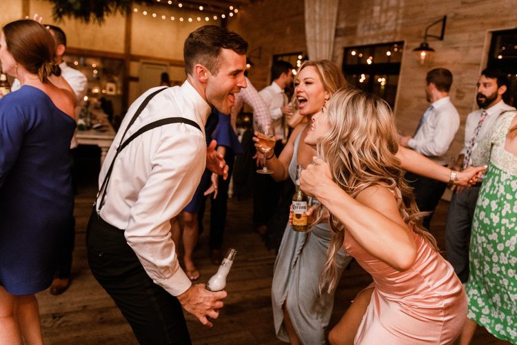 Guests singing and dancing together on the dance floor.
