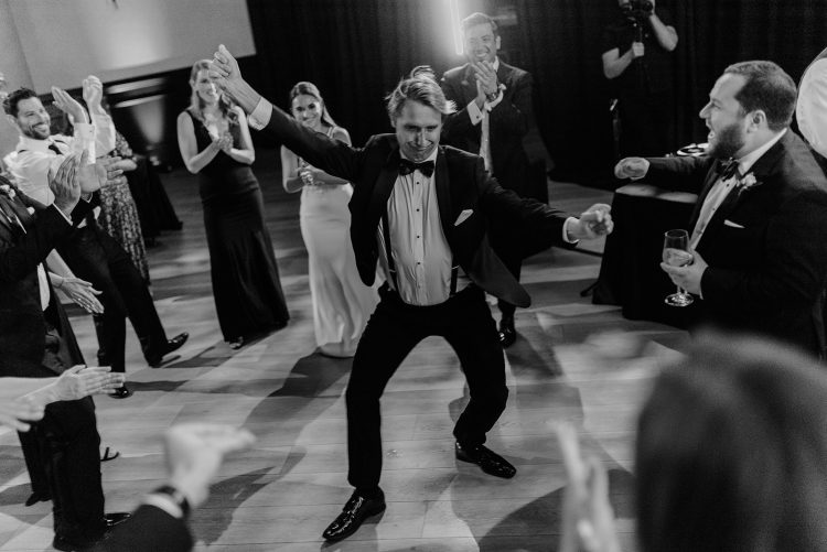 Guest dancing in the center of a cheering circle.