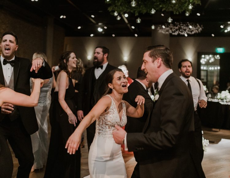 Bride singing and dancing with a guest.