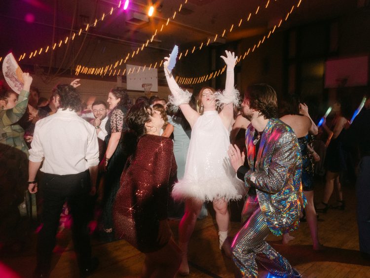Bride celebrating wildly on the dance floor.