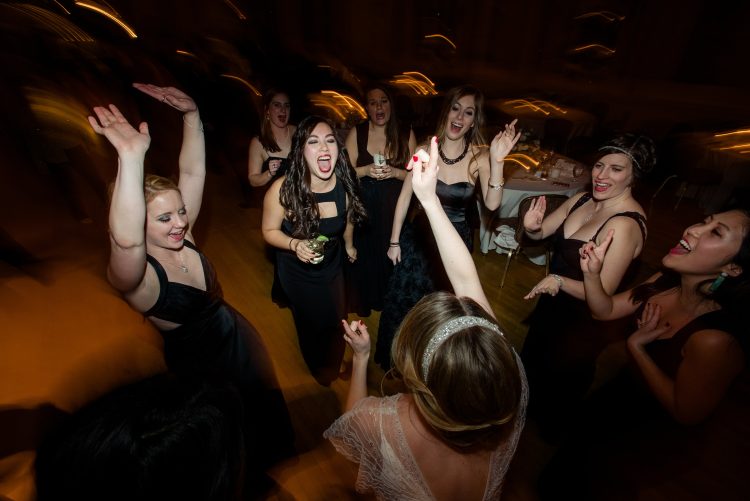 Bride dancing with friends in a lively circle.