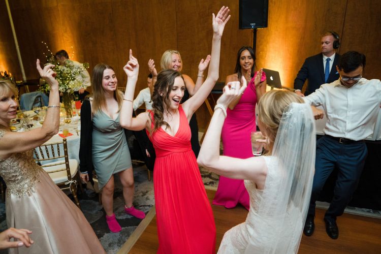 Group of guests dancing at a wedding reception.