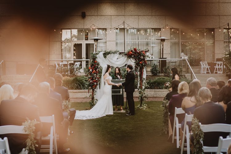 Outdoor wedding ceremony with bride and groom at the altar.