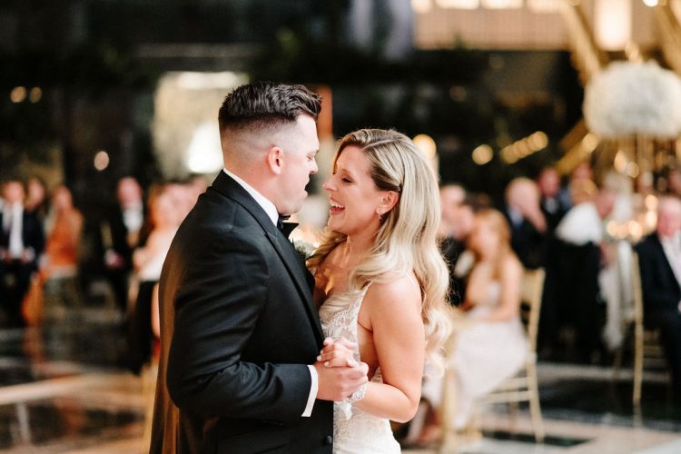 Bride and Groom smiling while dancing together.