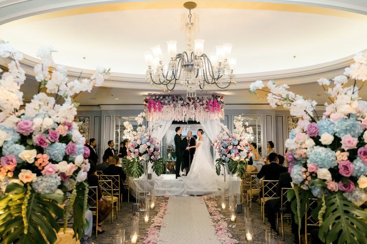 Bride and Groom at the altar during an indoor wedding ceremony at The Pierre Hotel.