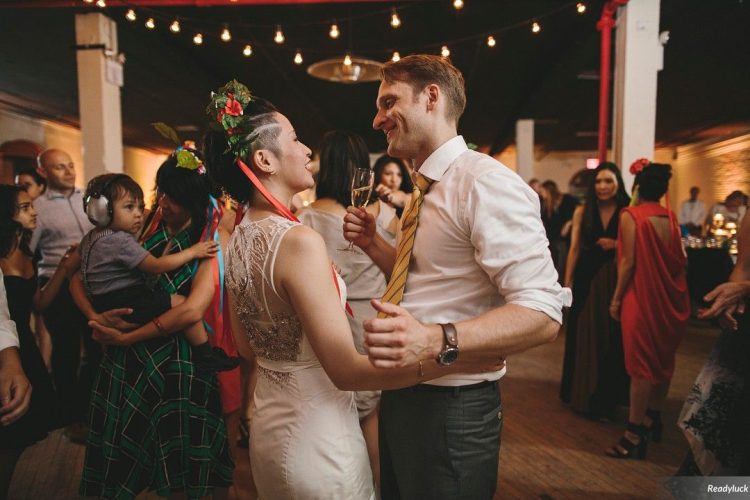 Bride and groom dancing together on lively reception dance floor at Liberty Warehouse