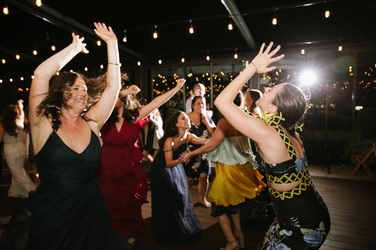 Wedding guests dancing energetically on reception dance floor at Box House Hotel