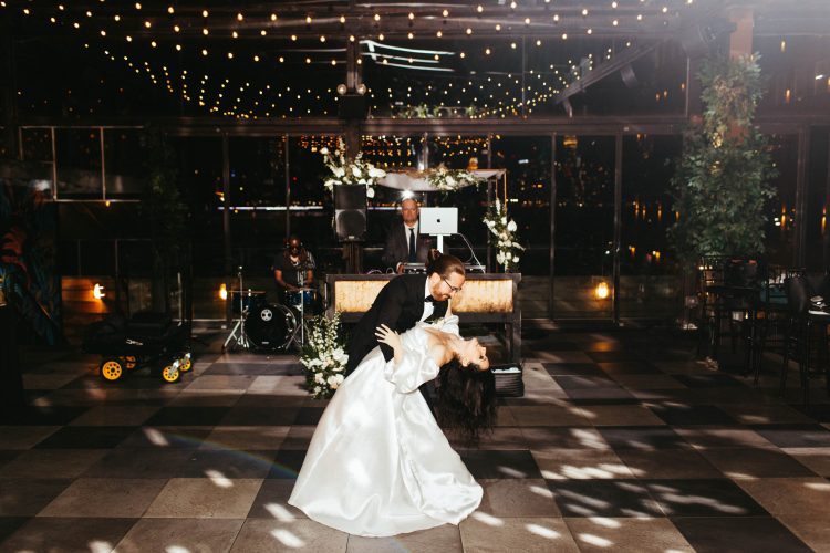 Bride and groom performing dramatic first dance dip at 74Wythe