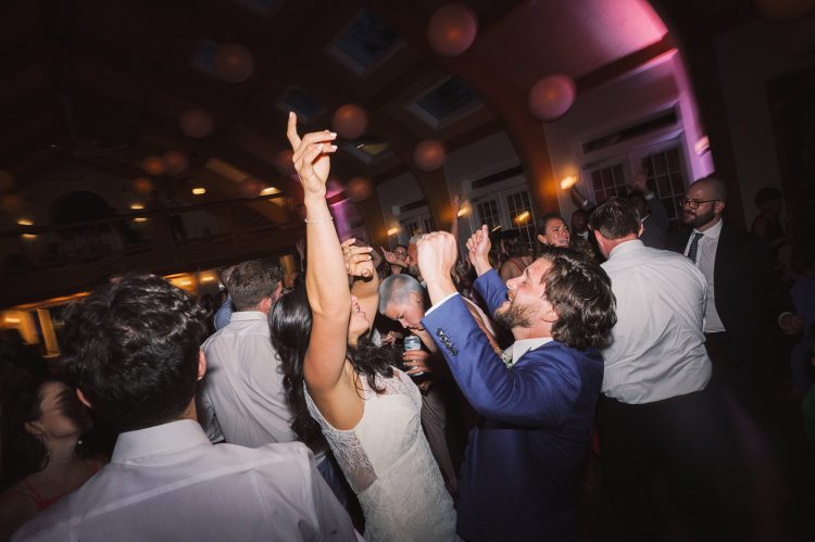 Bride dancing with wedding guests during lively reception celebration