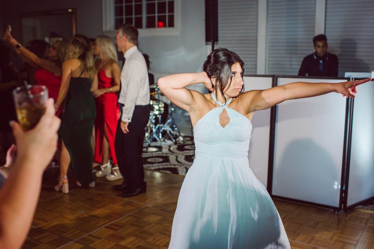 Fun wedding reception moment with a bold dance move.