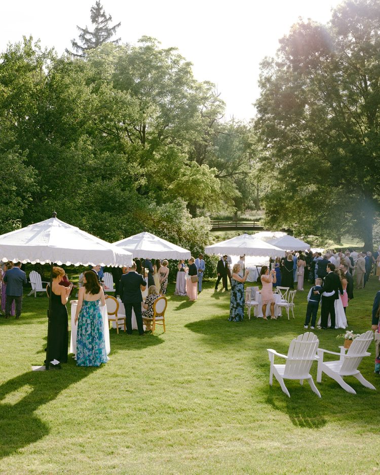 Relaxed outdoor wedding cocktail hour with a beautiful garden setting.