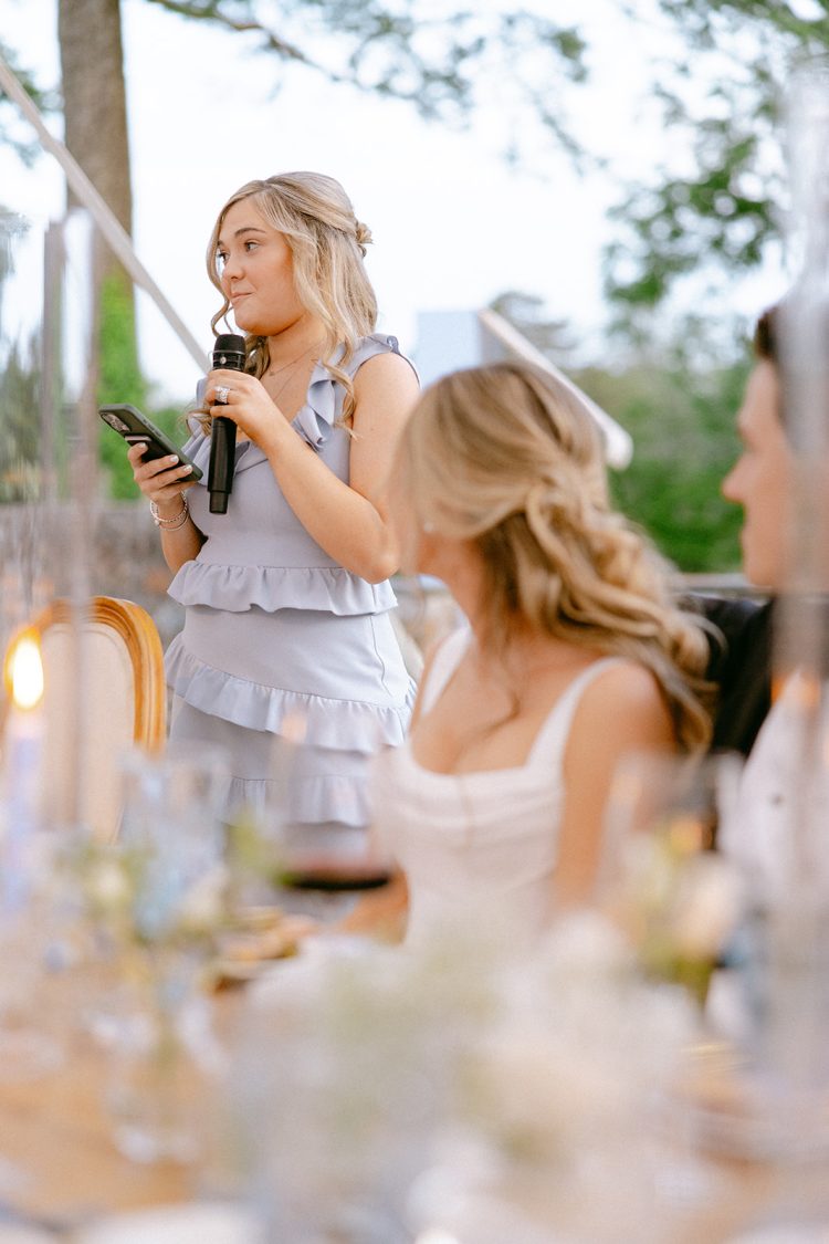 Heartfelt wedding toast moment, warm and intimate.