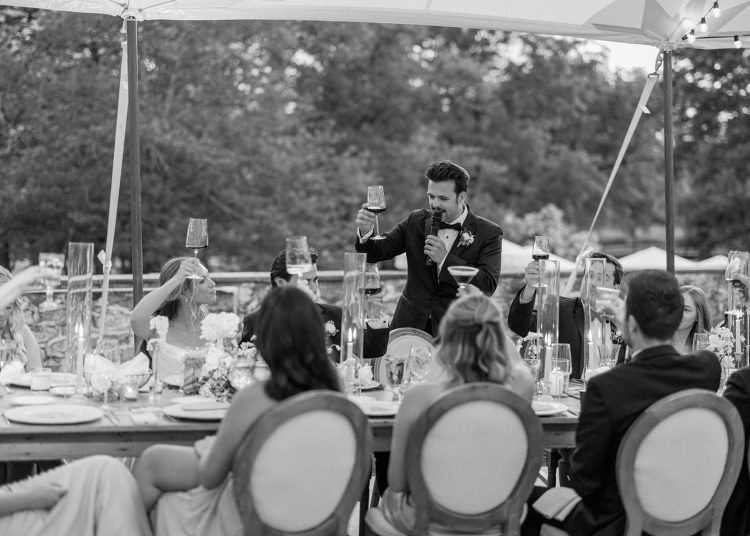 Classic wedding toast moment with everyone celebrating together.