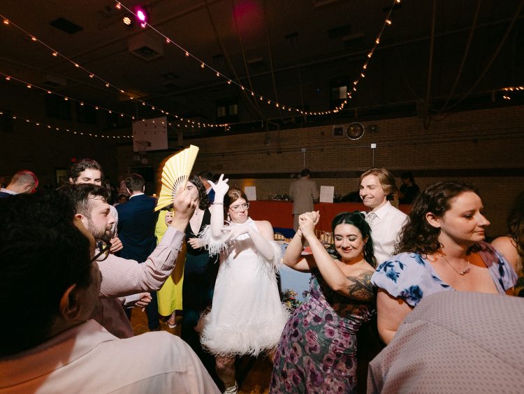 Fun wedding dance floor moment with guests letting loose and celebrating together.