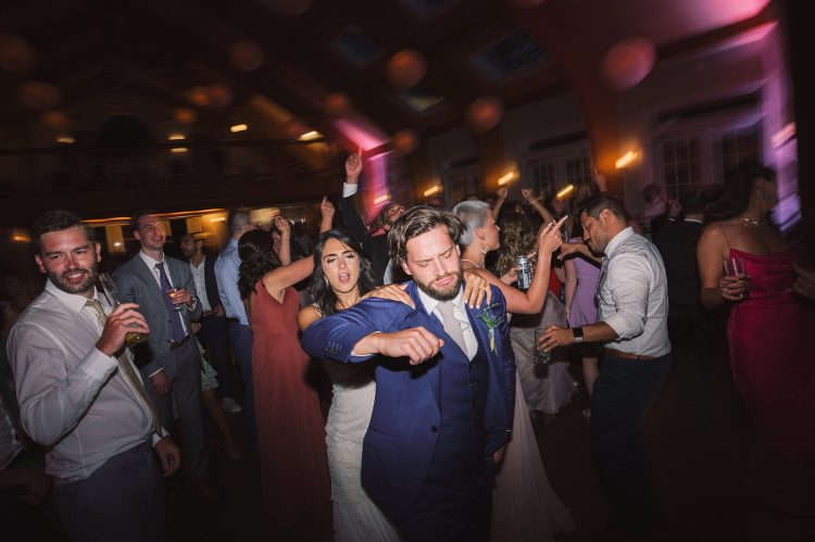 Wedding dance floor with guests celebrating and lively energy.