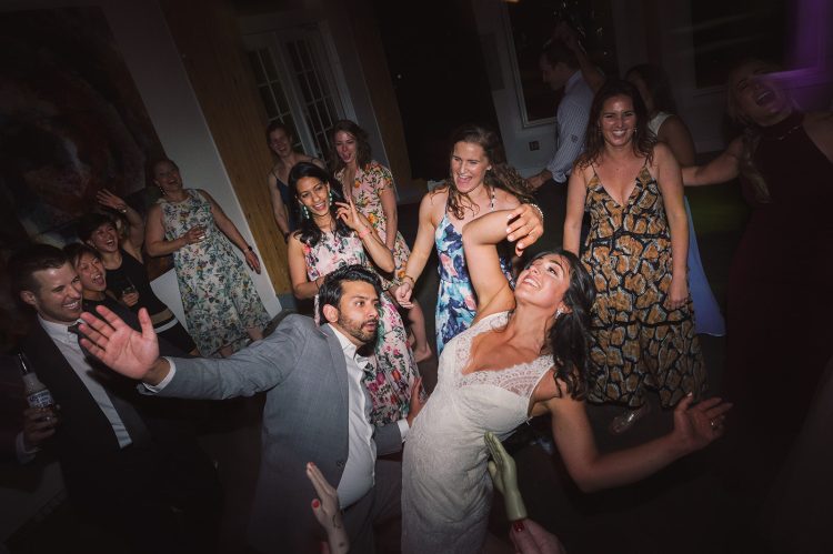 Wedding dance floor with guests celebrating and playful energy.