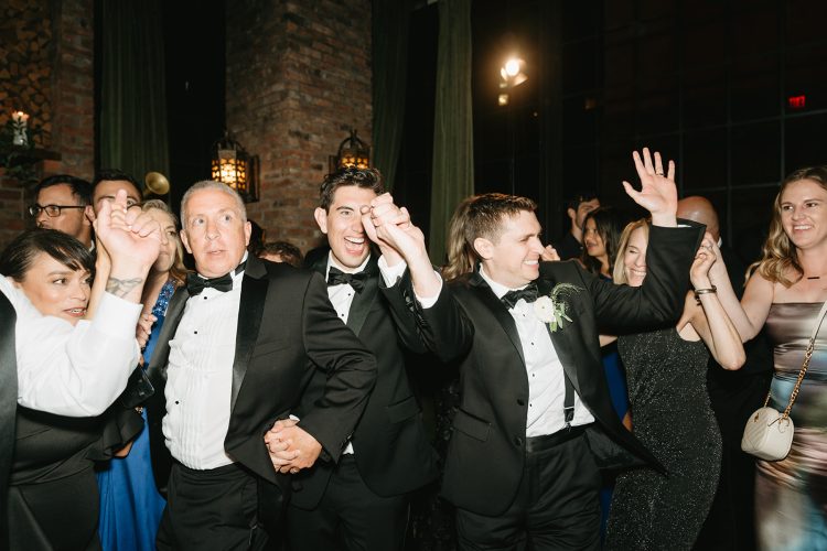 Guests celebrating and dancing together at the reception.