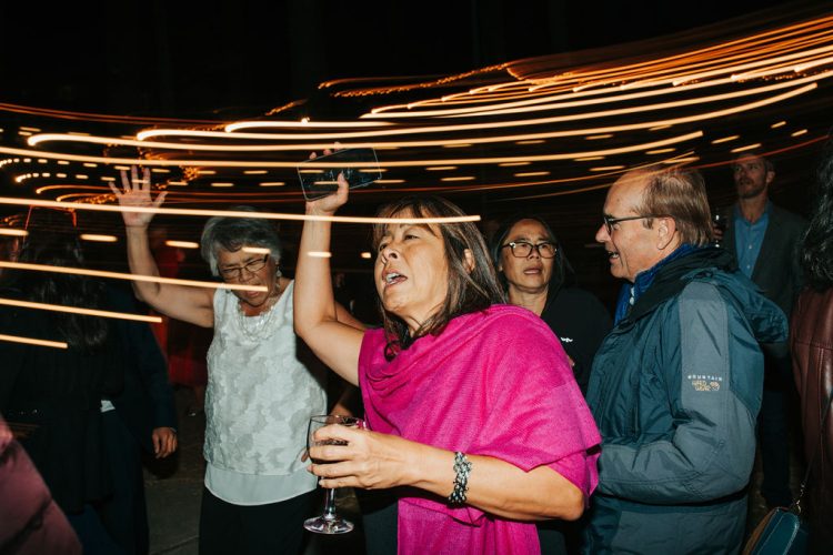 Guests dancing with motion blur and light trails.