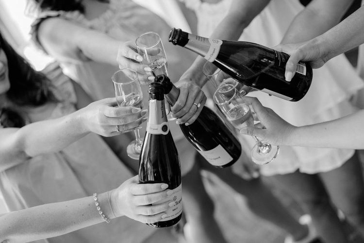 Bridal party raising champagne glasses during wedding celebration