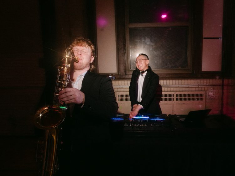 Live saxophonist performing alongside wedding DJ during reception